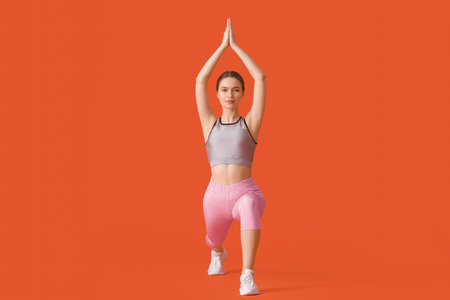 Sporty young woman doing yoga on color backgroundの写真素材