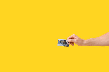 Hand with gift card on color backgroundの写真素材
