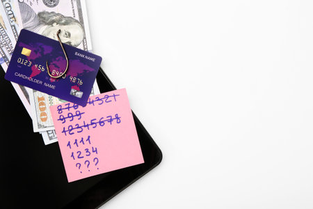 Composition with tablet computer, credit card and money on white background. Hack conceptの写真素材