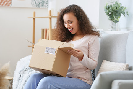 Young woman with parcel at home
