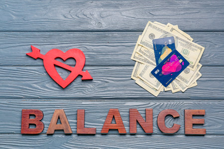 Dollar banknotes with credit cards and heart on wooden background. concept of balanceの写真素材