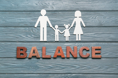 Figure of family on wooden background. concept of balanceの写真素材