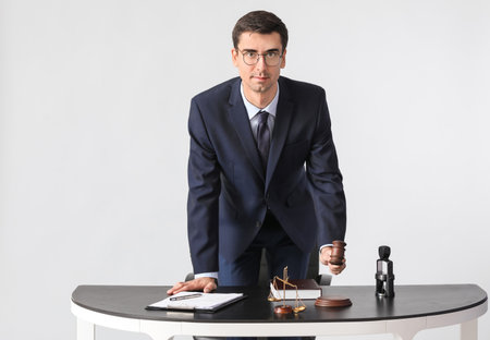 Male judge at table on gray backgroundの写真素材