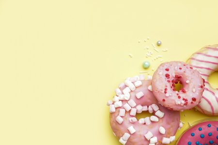 Tasty glazed donuts on yellow backgroundの写真素材