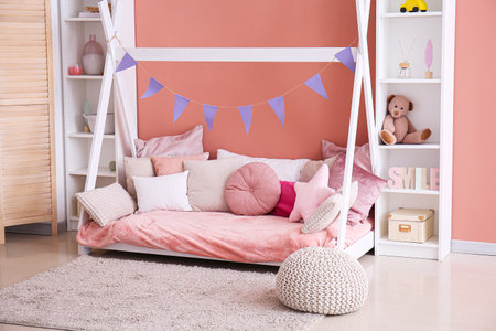 Stylish interior of children's room with baby bedの写真素材