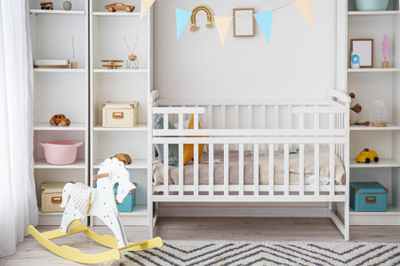 Stylish interior of children's room with baby bedの写真素材