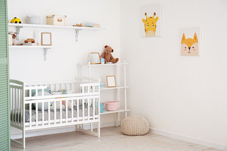 Stylish interior of children's room with baby bedの写真素材