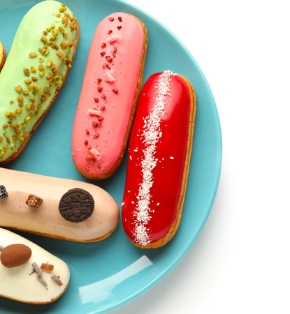 Plate with various glazed eclairs isolated on white background