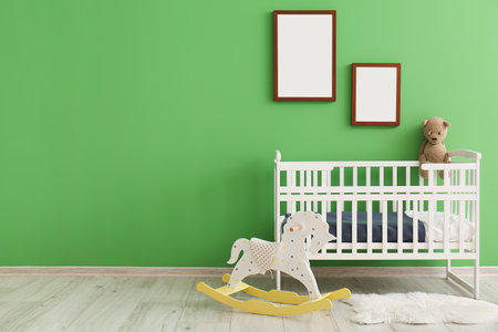 Stylish interior of children's room with baby bedの写真素材