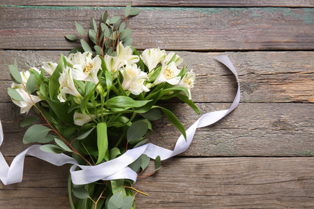 Beautiful bouquet of alstroemeria flowers on wooden backgroundの写真素材
