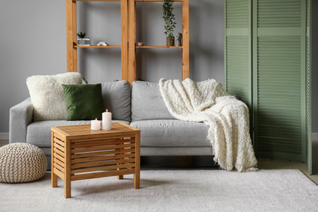 Interior of living room with sofa, shelving unit and folding screenの写真素材