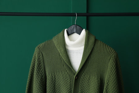 Rack with stylish clothes near green wall, closeupの写真素材