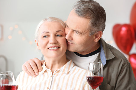 Mature couple celebrating Valentine's Day at homeの写真素材