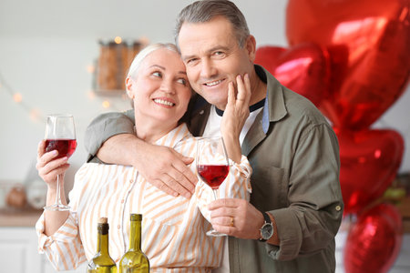 Mature couple celebrating Valentine's Day at homeの写真素材