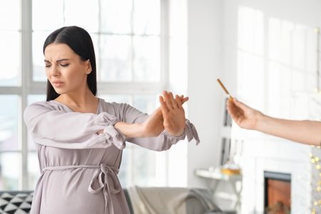 Young pregnant woman refusing to take suggested cigarette. concept of healthy lifestyleの写真素材