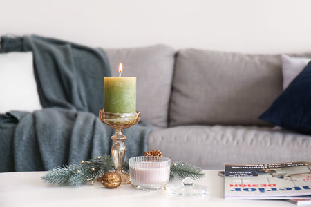 Aroma candles with Christmas decor on table in roomの写真素材