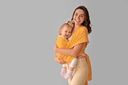 Happy woman and her little daughter on light backgroundの写真素材