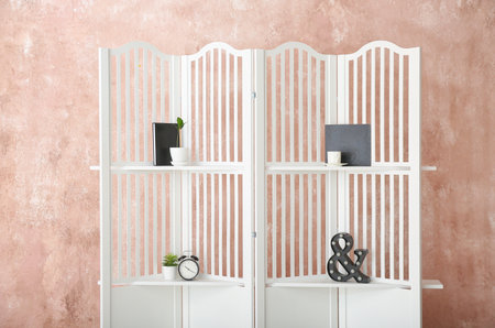 Folding screen with alarm clock and decor near color wallの写真素材