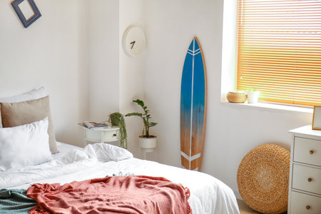 Interior of modern bedroom with surfboardの写真素材