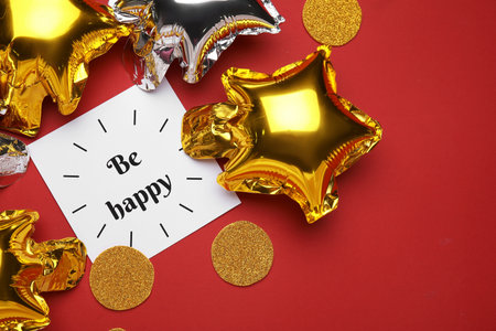 Beautiful different balloons and text BE HAPPY on red background
