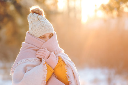 Young woman in warm clothes walking on winter day