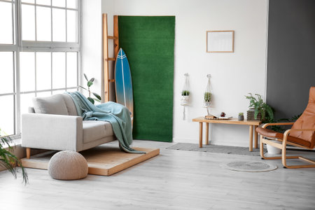 Interior of stylish room with surfboard and sofaの写真素材