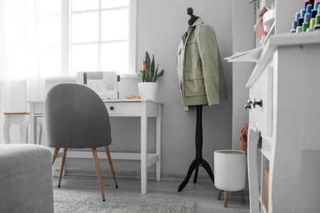 Interior of light atelier with tailor's workplace and mannequinの写真素材
