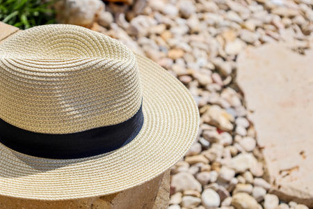 Summer hat on stone fence in park, closeup