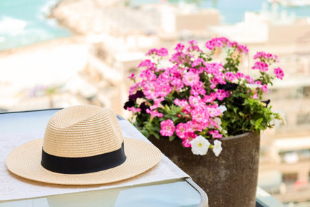 Table with summer hat on balcony, closeupの写真素材