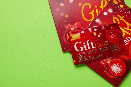 Gift cards on color background, closeup