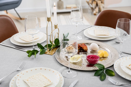 Passover Seder plate with traditional food on served tableの写真素材