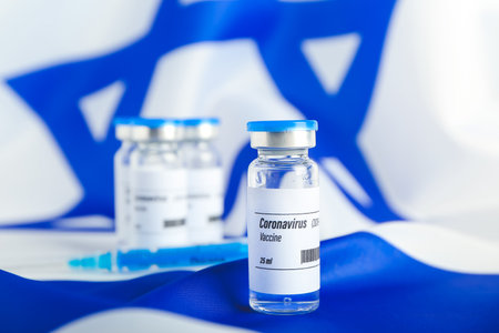 Vaccine for immunization against COVID-19 on flag of Israelの写真素材