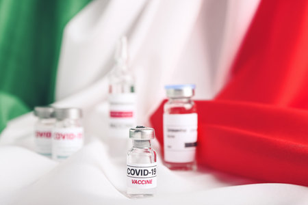 Vaccine for immunization against COVID-19 on flag of Italyの写真素材
