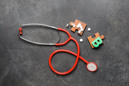 Letter B with stethoscope and pills on dark backgroundの写真素材