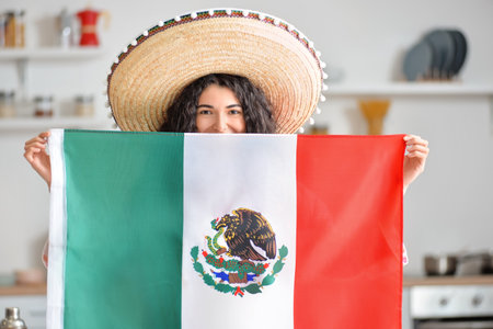 Young woman in sombrero hat with Mexican flag at homeの写真素材