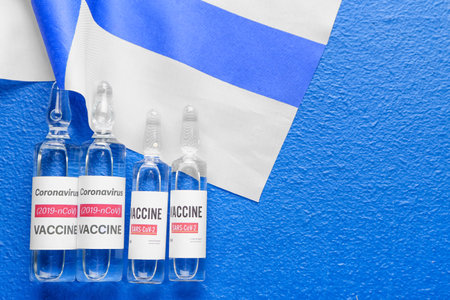 Vaccine for immunization against COVID-19 and flag of Finland on color backgroundの写真素材