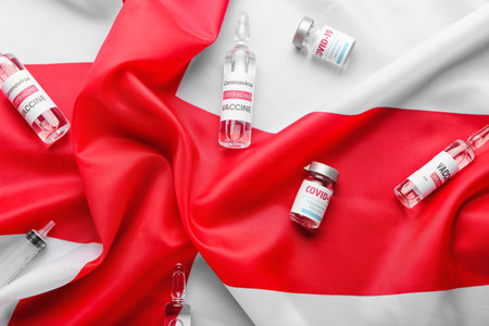 Vaccine for immunization against COVID-19 on flag of Englandの写真素材