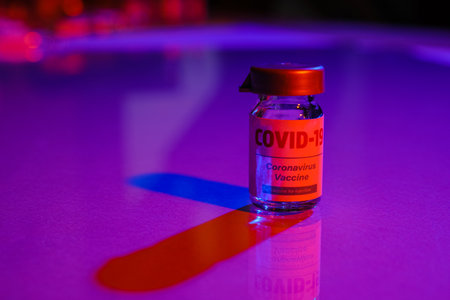 Vaccine for immunization against COVID-19 on color backgroundの写真素材