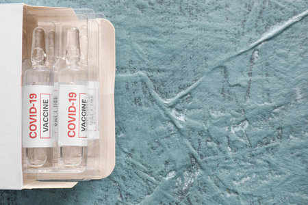 Vaccine for immunization against COVID-19 on gray background