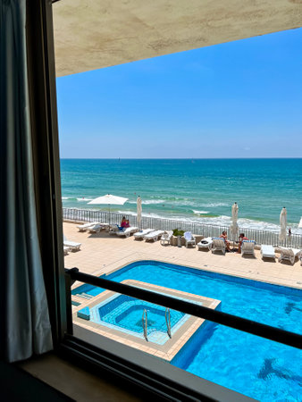 View from window at beach pool on sunny dayのeditorial素材