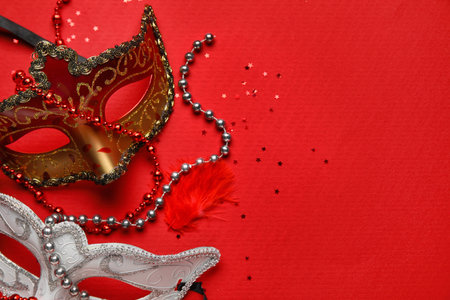 Carnival masks for Mardi Gras celebration with stars and beads on red background, closeupの写真素材
