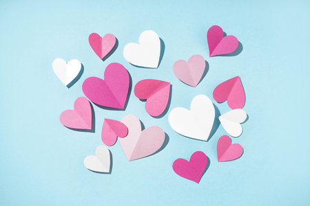 Beautiful paper hearts on blue background. valentine's day celebration