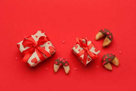 Fortune cookies with gifts on red background. Valentine's Day celebrationの写真素材