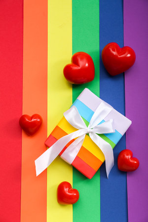 Gift box with hearts on paper sheets in colors of LGBT flag. Valentine's Day celebrationの写真素材