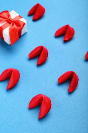 Fortune cookies with gift on blue background, closeup. Valentine's Day celebrationの写真素材