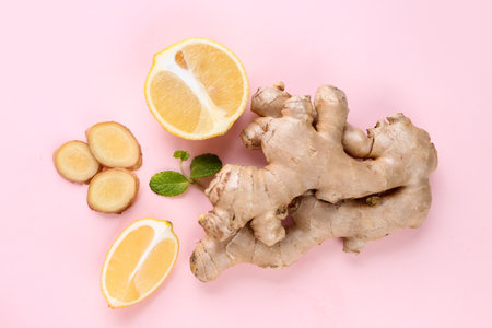 Fresh ginger roots and lemons on pink backgroundの写真素材