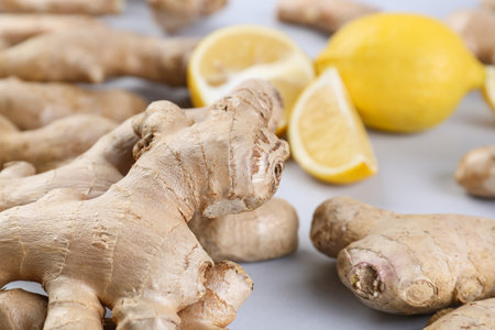 Fresh ginger roots on gray background, closeup