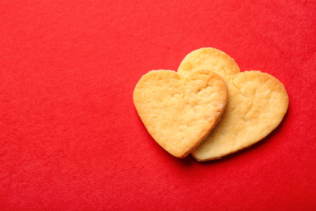 Sweet heart shaped cookies on red background. valentine's day celebrationの写真素材