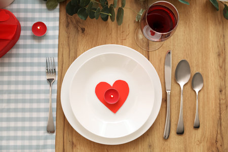 Table setting for Valentine's Day with candles in dining room, top viewの写真素材