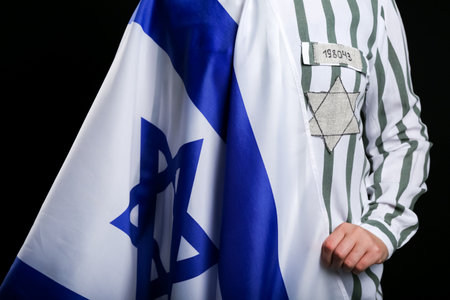 Jewish female prisoner with flag of Israel on dark background, closeup.の写真素材